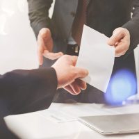businessman-giving-document-businessman